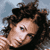 Pixelated close-up of a person with curly dark hair against a light blue background, rendered in low-resolution 50x50 pixels with visible dithering and color blending.