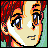 Pixelated anime-style face with red hair, large eyes showing blue and brown irises, a small nose, and a neutral mouth expression against a green background.
