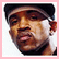 Two side-by-side pixelated portrait frames of a person wearing a cap, one in color and one in grayscale, displayed on a pink background.