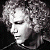 Two figures with curly hair in grayscale, one facing left and the other right against a dark background.