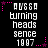 Pixelated text and pink star accents on a black background, with repeated text elements and animated star positions.