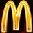 A pixelated golden letter M with a glowing outline against a dark background, rendered in a low-resolution style.