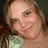 A static pixelated image shows a person with light brown hair wearing a light green top against a dark background.