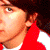 A four- shows a person with brown hair in various poses: left wearing red and white clothing, top-right showing curly hair texture, bottom-left with eyes closed and green headband, bottom-right holding blue earphones