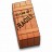 A pixelated vertical image shows a brown rectangular object with a lighter top section and dark brown base, featuring a dark brown checkered pattern on its side.