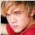 Two side-by-side frames of a low-resolution animated buddy icon showing a person in red clothing transitioning to grayscale.