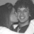 Black-and-white photo of two people embracing on left; pink background with pixelated Spanish text 'Eres el amor de mi vida.' on right.