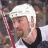 Pixelated image of a hockey player wearing white helmet and dark jersey with light trim, holding red stick, next to Pittsburgh Penguins logo and text "Steve McKenna #23".