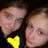 Two pixelated faces in close proximity with a yellow heart symbol below them against a dark background.