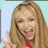 Pixelated image of a person with long blonde hair making a peace sign, accompanied by blue pixelated text reading "Miley Cyrus's FAN!!!" on white background.