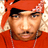 Pixelated static image of a person wearing an orange hooded garment with black accents and visible facial features including eyes, nose, mouth, and beard stubble.