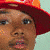 A 50x50 pixel animated buddy icon featuring a child in red clothing and an orange hat, shown across three frames with subtle pose changes against a light green background.