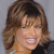 Static 50x50 pixel icon showing a close-up of a person with brown wavy hair, light skin tone, and visible teeth in a smile against a gray background.