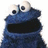 Blue puppet-like character with large eyes and open mouth on white background, blue text 'HES', 'SO', 'PIMPIN' on red background.
