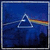 A static pixelated image shows a white triangular prism with a rainbow spectrum refracting from its right side against a dark blue background.