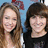 Two people with long brown hair and short dark hair stand side-by-side against a blue background, smiling at the camera.