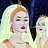Static pixelated image of two stylized figures with light-colored hair against a dark background, one figure partially overlapping the other.