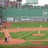 A static image with a red background divided into four sections, featuring text and a small baseball field scene.