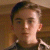 Static 50x50 pixel buddy icon showing a close-up of a person's face with dark hair and light skin, rendered in low-resolution pixel art style against a brown background.