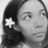 Black-and-white pixelated image of a person with long dark hair and a white star-shaped accessory on the left side.
