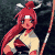 Pixelated anime-style character with red hair tied in a high ponytail, holding a long staff-like object against a dark background.