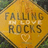 A diamond-shaped icon with a yellow-orange gradient background displays text reading "FALLING IN LOVE ROCKS" and a pixelated heart symbol below the text.