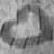 Grayscale pixelated icon with abstract light and dark shapes forming a central bright area surrounded by darker irregular forms.