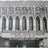 Pixelated grayscale image of a building facade with vertical columns and a horizontal base, appearing as a low-resolution static icon.