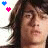 A pixelated image of a person with long dark hair, two heart icons floating above the head in different positions across frames.