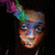 Pixelated image of a person with multicolored hair against black background, showing partial face and upper body.