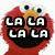 Pixelated red character with large white eyes and orange nose, displaying text in black-and-white block letters across its mouth area.