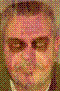 Pixelated static image of a person's face with visible dithering and color blending, rendered in low resolution with warm tones.