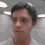 Four identical pixelated headshots of a person with short dark hair in a white shirt against a gray background with ceiling lights.