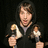 A pixelated figure in dark clothing holds two small objects against a black background with red text reading "JWalk..." and "Bratz Dolls".
