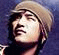 A pixelated image of a person wearing a light-colored beanie, with visible text 'NEW' in the bottom right corner.