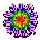 A circular pixelated icon with a central red core surrounded by green, yellow, and blue rings, bordered by purple and pink floral-like patterns on a gray background.