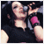 A woman with long dark hair sings into a microphone, wearing a black sleeveless top and pink wristbands across three animated frames showing different poses.