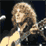 Animated contact sheet of a musician with long curly hair playing an electric guitar, transitioning to band name text on stage background.