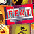 Red 'RENT' sign with silver accents on a yellow background featuring a cowboy figure, repeated in a pattern