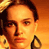Pixelated close-up of a person's face with warm orange and yellow tones, likely from an old digital image or low-resolution scan.