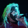 nine showing a person with face paint singing into a microphone under stage lights, transitioning to 'Dark Lotus' text logos