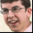 A pixelated split-screen image shows a person with short dark hair and glasses, smiling broadly in both , with the right displaying the text "McLovin" above the head