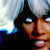 Pixelated close-up of a figure with dark hair and a dark top against a light blue and white background.
