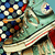 Pixelated green sneakers with white and red stripes, blue star on side, and colorful dot pattern on upper, shown in three slightly different views.