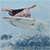Animated contact sheet of three surfing frames showing a person performing aerial tricks on a surfboard against ocean background.