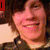 A four- shows a person with brown hair and a dark jacket, smiling in the top-left while other display text overlays