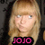 Pixelated image of a person with light brown hair and fair skin, wearing black clothing with pink text reading JOJO at the bottom.