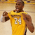 Pixelated image of a person in a yellow jersey with number 24, arms raised, on a light brown background.