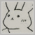 Pixelated grayscale icon of a stylized face with curved lines forming ears, a U-shaped mouth, and two small dots for eyes on a light background.