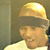 Pixelated static image of a person wearing a yellow hard hat and light-colored shirt against a neutral background.